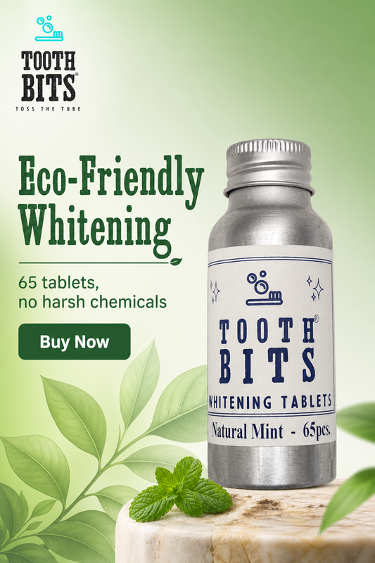 Tooth Bits eco-friendly whitening tablets in a silver bottle with a white label, displayed on a wooden block with mint leaves against a green gradient background with promotional text.